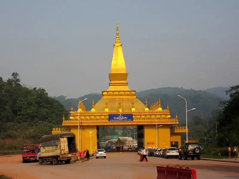 Gilded stupa gateway over the road at Boten International Check Point