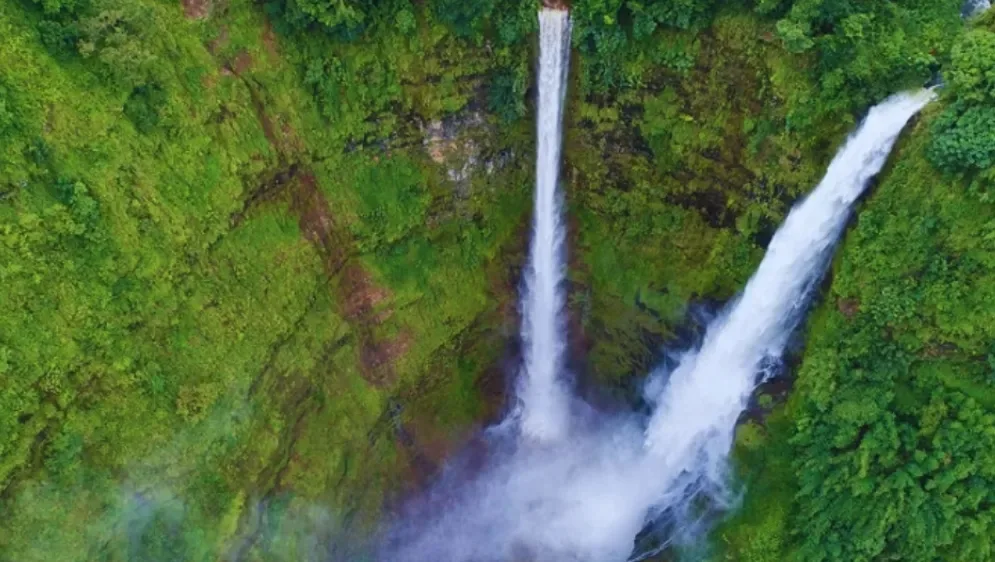 Twin waterfalls cascading through rainforest on the Bolaven Plateau near Pakse